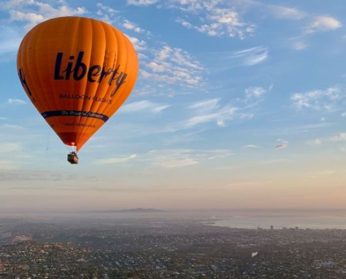 Balloon floating above Geelong and Corio Bay at sunrise